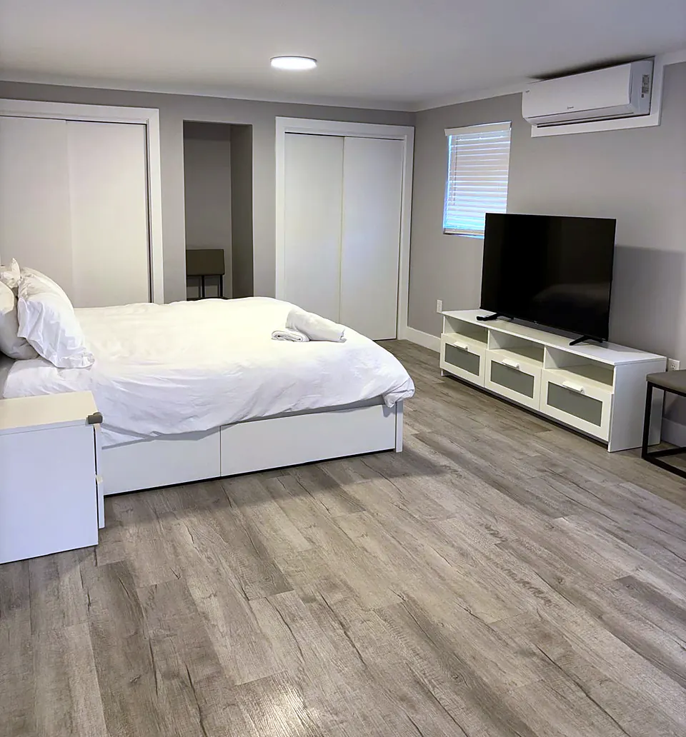 Guest bedroom in a short-term rental made up with fresh linens and tidy surfaces, staged for the next check-in.
