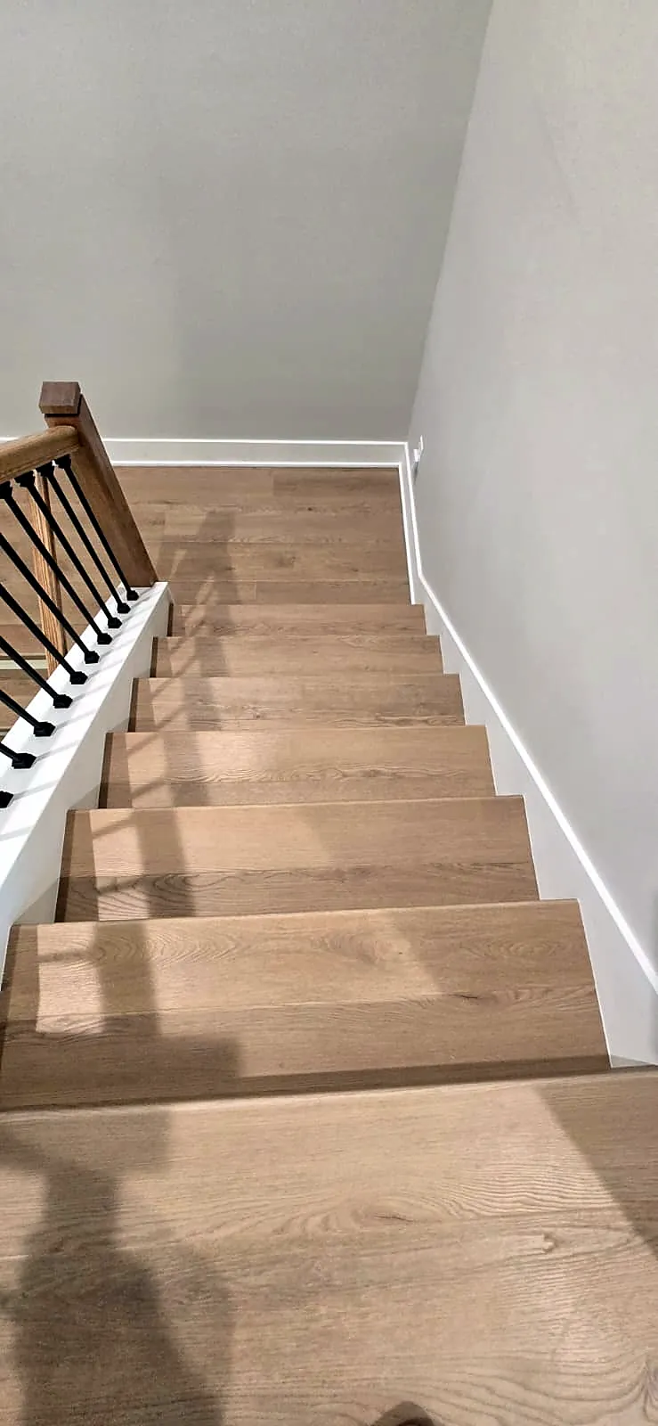 Oak-look stair treads seen from the top of the staircase